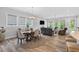 Open-concept living area with a dining table, living room seating, and abundant natural light at 365 Middleton Pl, Chapel Hill, NC 27516