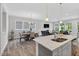 Bright living space featuring wood floors, a dining table, and a kitchen with a large center island at 365 Middleton Pl, Chapel Hill, NC 27516