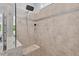 Modern bathroom shower featuring neutral tiled walls, glass enclosure, and overhead shower nozzle at 365 Middleton Pl, Chapel Hill, NC 27516