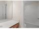 Bathroom with white cabinets and a shower and tub at 3812 Covina Dr, Raleigh, NC 27613