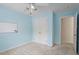 Bedroom features a closet, a ceiling fan with natural light, neutral carpet, and pale-blue painted walls at 3812 Covina Dr, Raleigh, NC 27613
