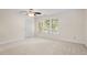 Spacious bedroom features neutral carpet, natural light from large windows, and white walls at 3812 Covina Dr, Raleigh, NC 27613