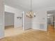 Open dining area with hardwood floors and decorative chandelier at 3812 Covina Dr, Raleigh, NC 27613