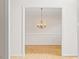 Dining area with hardwood floors and a traditional chandelier at 3812 Covina Dr, Raleigh, NC 27613