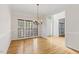 Dining room featuring hardwood floors and a vintage-style chandelier at 3812 Covina Dr, Raleigh, NC 27613