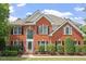 Charming red brick home featuring a manicured lawn and traditional architectural details at 3812 Covina Dr, Raleigh, NC 27613