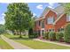 Stately brick home with mature trees, manicured lawn, and a welcoming facade at 3812 Covina Dr, Raleigh, NC 27613