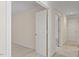 Hallway with neutral carpet, and white walls with bright brass-colored hardware on doors at 3812 Covina Dr, Raleigh, NC 27613