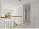 Hallway features a chandelier, carpet flooring, crown molding, and an arched window letting in natural light at 3812 Covina Dr, Raleigh, NC 27613
