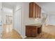 Hallway with desk area, storage cabinets, hardwood floors and stairway at 3812 Covina Dr, Raleigh, NC 27613