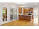 Eat-in kitchen featuring wood cabinets, island, stainless steel appliances, hardwood floors and backyard access at 3812 Covina Dr, Raleigh, NC 27613