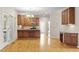 Eat-in kitchen features wood cabinets, stainless steel appliances, hardwood floors, and backyard access at 3812 Covina Dr, Raleigh, NC 27613