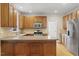 Kitchen features stainless steel appliances, wood cabinets and hardwood floors at 3812 Covina Dr, Raleigh, NC 27613
