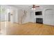 Bright living room with hardwood floors, fireplace, built-in shelves, and staircase at 3812 Covina Dr, Raleigh, NC 27613