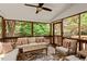 Screened porch with a ceiling fan and outdoor seating area at 3812 Covina Dr, Raleigh, NC 27613