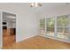 Bright sunroom features hardwood floors, a ceiling fan, and large windows overlooking a wooded area at 3812 Covina Dr, Raleigh, NC 27613