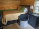 Cozy bedroom with wood paneled walls, comfortable bed, and bedside table at 4008 Old Nc 86, Hillsborough, NC 27278