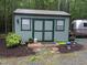 Exterior shot of a shed with double doors, windows, and a charming rustic design at 4008 Old Nc 86, Hillsborough, NC 27278