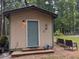 Home exterior with green door, wood siding, and a decorative lizard at 4008 Old Nc 86, Hillsborough, NC 27278