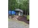 Charming outdoor shed with a small porch, stepping stones, and surrounded by lush greenery at 4008 Old Nc 86, Hillsborough, NC 27278