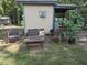 Outdoor seating area featuring a wicker sofa, two chairs, and a coffee table, shaded by a tree at 4008 Old Nc 86, Hillsborough, NC 27278