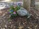 Whimsical fish statue nestled beside a tree with colorful hydrangeas in a natural garden setting at 4008 Old Nc 86, Hillsborough, NC 27278