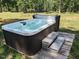 Relaxing hot tub surrounded by lush greenery, creating a serene outdoor oasis at 4008 Old Nc 86, Hillsborough, NC 27278