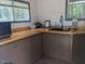 The kitchen has a butcher block countertop, with wooden cabinets and a window view at 4008 Old Nc 86, Hillsborough, NC 27278
