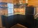 Kitchenette featuring black cabinets, shelving, Galanz fridge, and stylish decor at 4008 Old Nc 86, Hillsborough, NC 27278