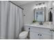 Bathroom featuring a toilet, shower with curtain, sink, and black hardware at 403 Carpenter Fletcher Rd, Durham, NC 27713