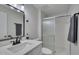 Bathroom featuring a toilet, shower with glass door, sink, and black hardware at 403 Carpenter Fletcher Rd, Durham, NC 27713