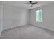 Bedroom with neutral carpet, ceiling fan, and window overlooking a grass lawn at 403 Carpenter Fletcher Rd, Durham, NC 27713