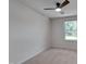 Neutral bedroom with a ceiling fan and bright window overlooking a grassy lawn at 403 Carpenter Fletcher Rd, Durham, NC 27713