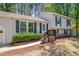 Home featuring lovely landscaping, neutral siding, and black shutters on the windows at 403 Carpenter Fletcher Rd, Durham, NC 27713
