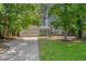 Charming home featuring a well-manicured lawn, a two-car garage, and mature trees at 403 Carpenter Fletcher Rd, Durham, NC 27713