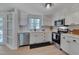 Updated kitchen featuring stainless appliances and modern white cabinetry at 403 Carpenter Fletcher Rd, Durham, NC 27713