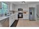 Bright kitchen featuring white cabinets, quartz countertops, and stainless steel appliances at 403 Carpenter Fletcher Rd, Durham, NC 27713