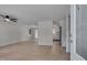 Open-concept living room with a ceiling fan, hardwood floors, and lots of natural light at 403 Carpenter Fletcher Rd, Durham, NC 27713