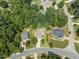Aerial view showcasing the home's location in a neighborhood with lush trees and well-maintained streets at 404 Blooming Meadows Rd, Holly Springs, NC 27540