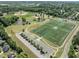 Expansive aerial view highlighting multiple baseball and athletic fields alongside a serene pond at 404 Blooming Meadows Rd, Holly Springs, NC 27540