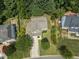 Aerial view of a home nestled among mature trees, highlighting its private backyard and neighborhood setting at 404 Blooming Meadows Rd, Holly Springs, NC 27540