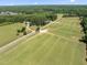 A sprawling green property with fields and a charming driveway, creating an inviting estate at 404 Blooming Meadows Rd, Holly Springs, NC 27540