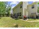 Green backyard features patio with an outdoor grill, seating, and well maintained landscaping at 404 Blooming Meadows Rd, Holly Springs, NC 27540