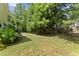 Expansive backyard featuring lush trees and green lawn, creating a private outdoor retreat at 404 Blooming Meadows Rd, Holly Springs, NC 27540
