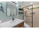 Modern bathroom with sleek vanity, glass shower, and contemporary fixtures for a clean design at 404 Blooming Meadows Rd, Holly Springs, NC 27540