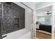 Modern bathroom featuring bathtub with black tile and gold accents, shower head, and curtain at 404 Blooming Meadows Rd, Holly Springs, NC 27540
