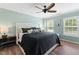Comfortable bedroom with natural light, a ceiling fan, and stylish decor at 404 Blooming Meadows Rd, Holly Springs, NC 27540