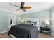Comfortable bedroom with a ceiling fan, a walk-in closet, and a neutral color palette for a relaxing atmosphere at 404 Blooming Meadows Rd, Holly Springs, NC 27540