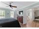 Bright bedroom includes ceiling fan, a dresser, TV, and multiple closets at 404 Blooming Meadows Rd, Holly Springs, NC 27540