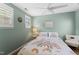 Charming bedroom with soft green walls, bright windows, and a comfortable, cozy bed at 404 Blooming Meadows Rd, Holly Springs, NC 27540